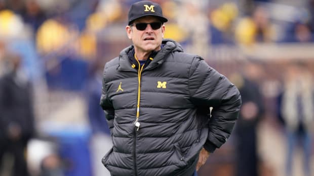 FILE - Michigan head football coach Jim Harbaugh watches an NCAA college football intrasquad spring game April 2, 2022, in Ann Arbor, Mich. Harbaugh’s eighth team is his first at Michigan that is coming off a win over Ohio State. The eighth-ranked Wolverines’ new challenge is to beat the Buckeyes on the road for the first time since 2000. (AP Photo/Carlos Osorio, File)